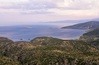Denize yakın Itea, Yunanistan, alacakaranlıkta bir dağın tepesine şaşırtıcı görünümünden