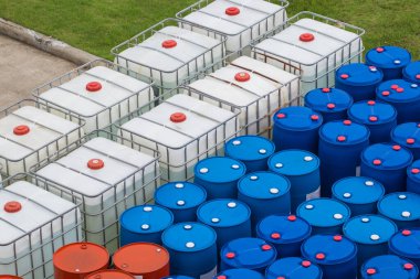 Petrol varilleri mavi ve beyaz veya kimyasal variller üst üste dizildi
