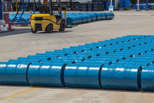 Oil barrels blue  chemical drums horizontal stacked up rear forklift lifts chemical drums
