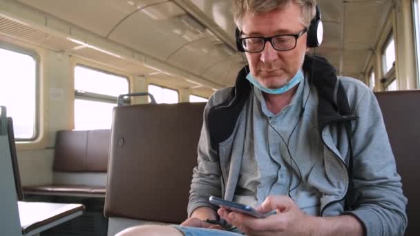 Middle Aged Man Sitting Empty Public Transport Wearing Headphones Protective — Stock Video