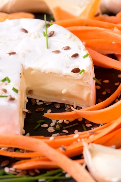 Camembert cheese with healthy seeds and corrot — Stock Photo, Image