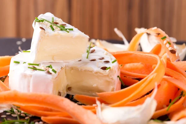 Portion of white camembert with carrot and chive — Stock Photo, Image