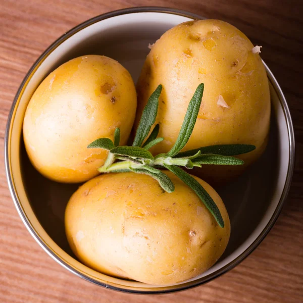 Three potatoes with skin in a pot — Stock Photo, Image