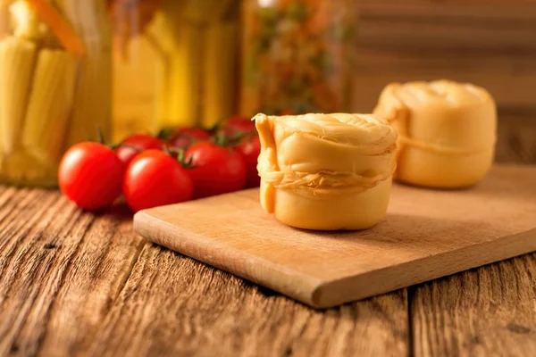 Steamed rolled cheese on wooden board — Stock Photo, Image