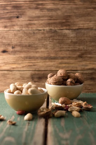 Two bowls with peanuts and walnuts — Stock Photo, Image