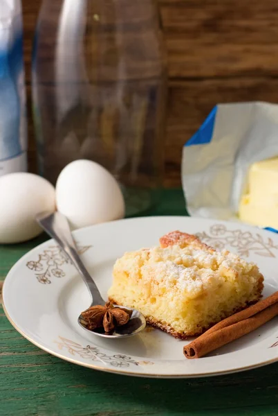 Fresh apple cake and star anise on spoon