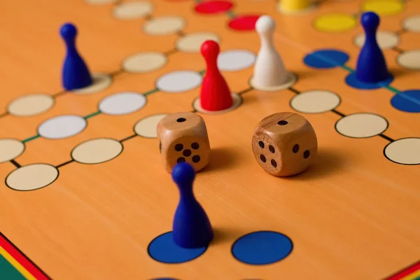 Couple of wooden dices on Ludo board — Stock Photo, Image