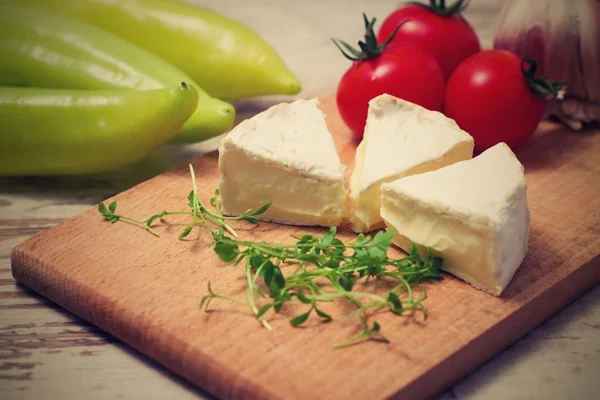 Vintage retro photo of three camembert portions — Stock Photo, Image