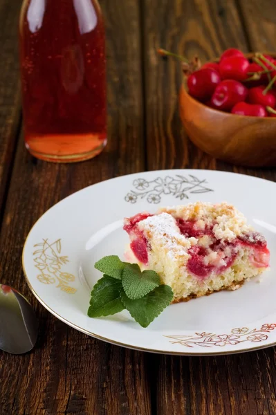 Sweet cherry pie with herb leaves on white plate — Stock Photo, Image