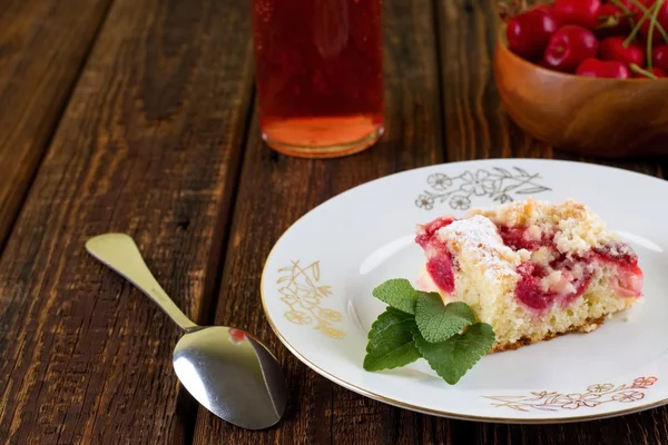 Fresh cherry pie on white plate with golden motif — Stock Photo, Image