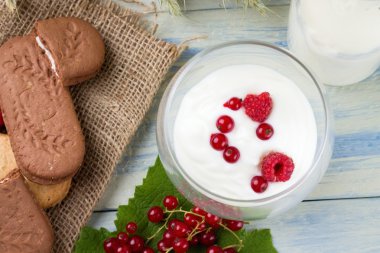 White yogurth with currant and raspberries clipart