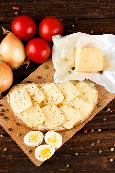 Top view on board with eggs bread and vegetable — Stock Photo, Image