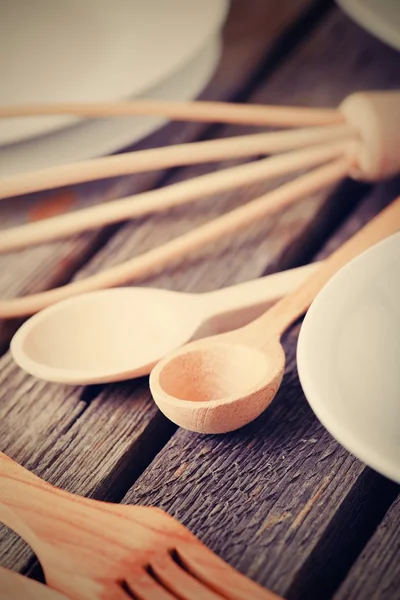 Vintage photo of wooden cutlery on old table — Stock Photo, Image