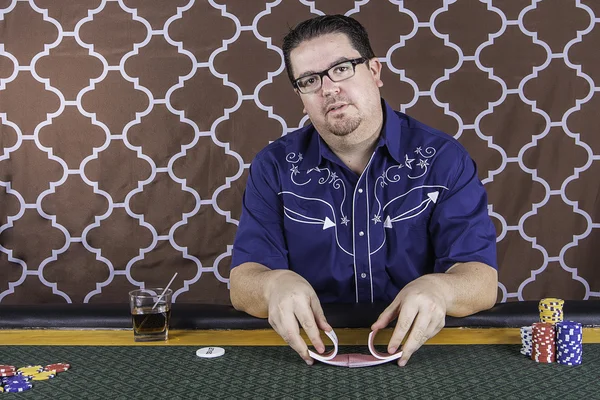 Un hombre jugando al póquer sentado en una mesa —  Fotos de Stock