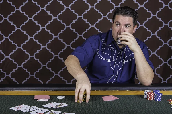 A man playing poker sitting at a table — Stock Photo, Image