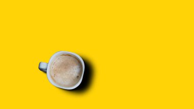 Top view, flat lay of black coffee cup on background yellow.