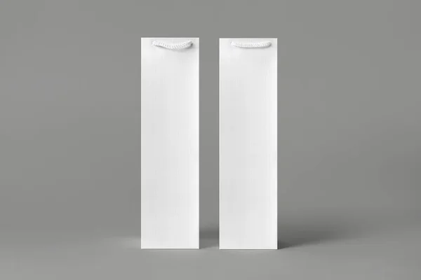 Blank tall white wine bottle bag mockup set, isolated, 3d rendering. Empty carry handbag for wine or vodka mock up. Clear paper packaging fit for store branding.