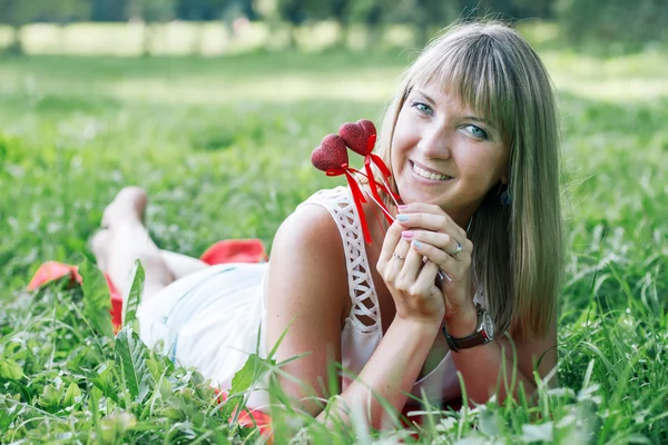 Mujer joven acostada en la hierba en el parque —  Fotos de Stock