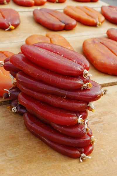 Pile of dried grey mullet roe on boards with sunlight — Stock Photo, Image