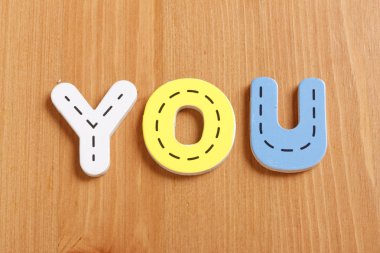 YOU, spell by woody puzzle letters with woody background clipart