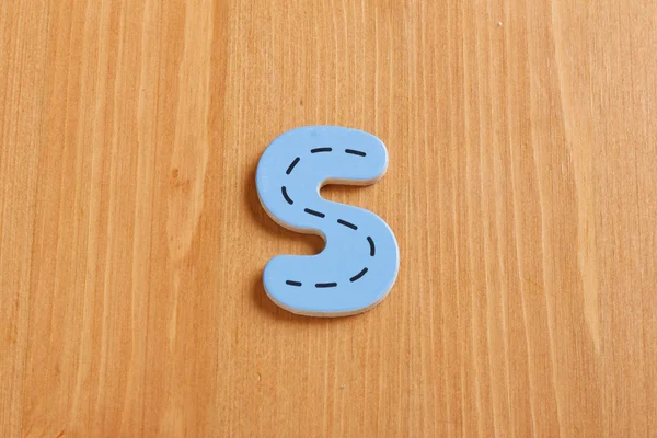 S, spell by woody puzzle letters with woody background — Stock Photo, Image