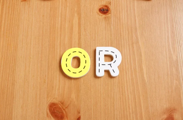 OR, spell by woody puzzle letters with woody background — Stock Photo, Image