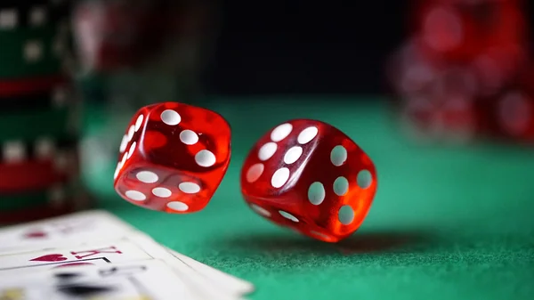 Red dice, casino chips, cards on green felt — Stock Photo, Image