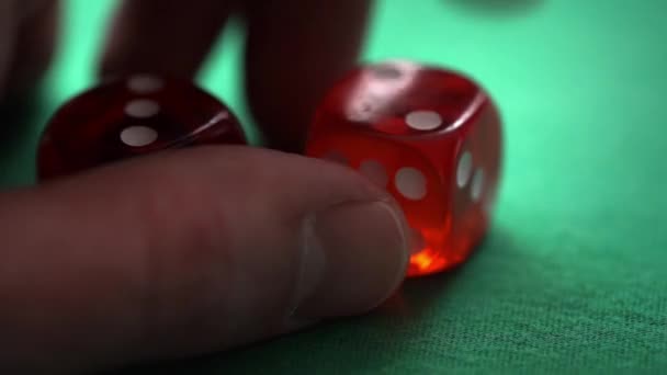 Red dice in hand on green table — Stock Video