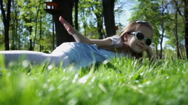 Beauty Girl lying on the Meadow with green grass — Stock Video