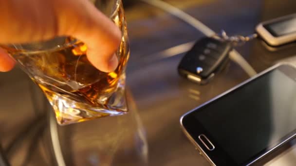 Glass of alcoholic drink and car key, on the table, light background — Stock Video