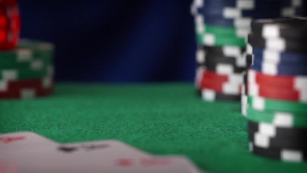 Red dice rolls, casino chips, cards on green felt — Stock Video