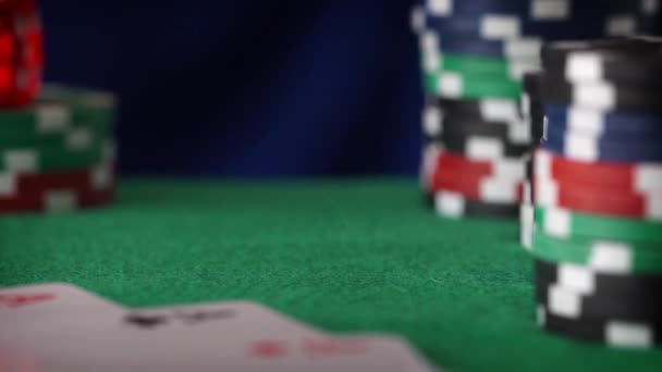 Red dice in sequence rolls, casino chips, cards on green felt — Stock Video