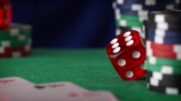 Red dice in sequence rolls, casino chips, cards on green felt — Stock Video