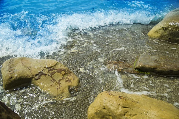 Deniz, kıyı ve taşlar. Güneş ışığı, deniz manzarası — Stok fotoğraf