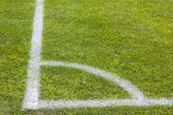 Campo da calcio angolo con segni bianchi, erba verde texture . — Foto Stock