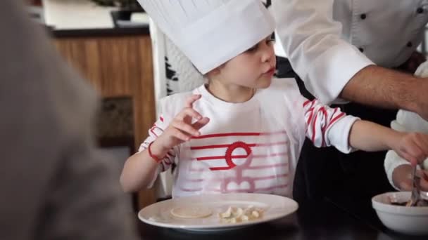 Baby girl in the cook hat — Stock Video