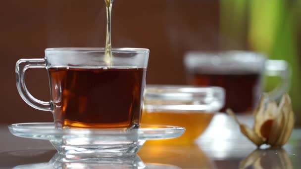 Transparent cup of tea on the table — Stock Video