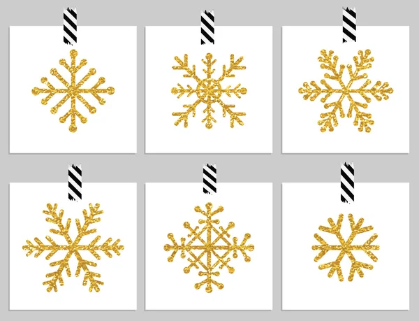 Set van gouden getextureerde sneeuwvlokken op kaarten — Stockvector