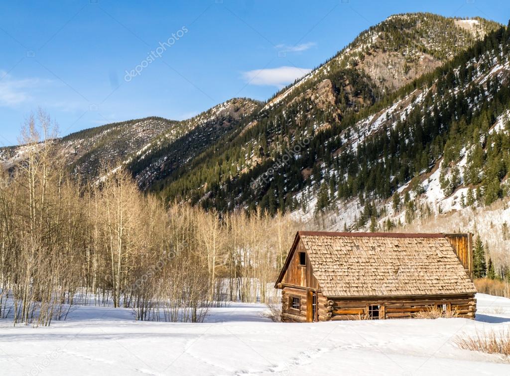 Solitary Abandoned Log Cabin in the Mountains