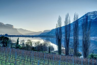 The Kaltern lake - Lago di Caldaro in South Tyrol, Italy in winter scenic view. clipart