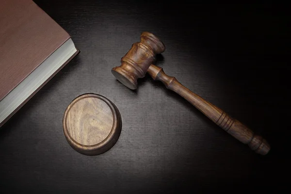 Judges Gavel And Law Book On Black Wood Background — Stok fotoğraf