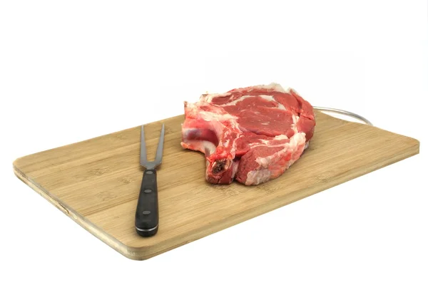 Raw Beef Steak, Fork On The Wood Cutting Board Isolated — Stock Photo, Image