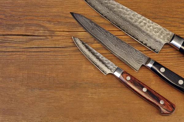 Japanese Professional Kitchen Knives On The Wood Cutting Board