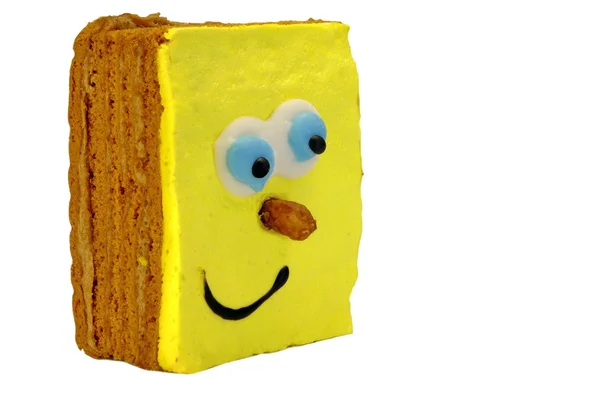 布朗尼蛋糕与人类微笑黄色的脸孤立在白色 — 图库照片