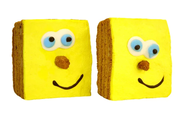 Два Брауні торт з людиною посміхаючись жовтим обличчям білі ізольовані — стокове фото