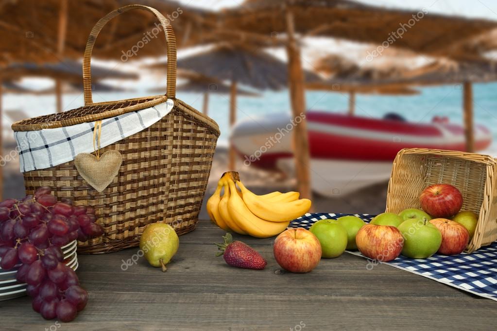 Picnic Table With Two Baskets And Fruits On The Beach ...