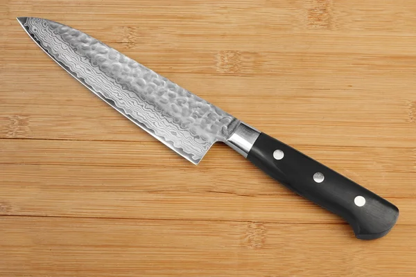 Japanese Professional Kitchen Knife On The Bamboo Cutting Board