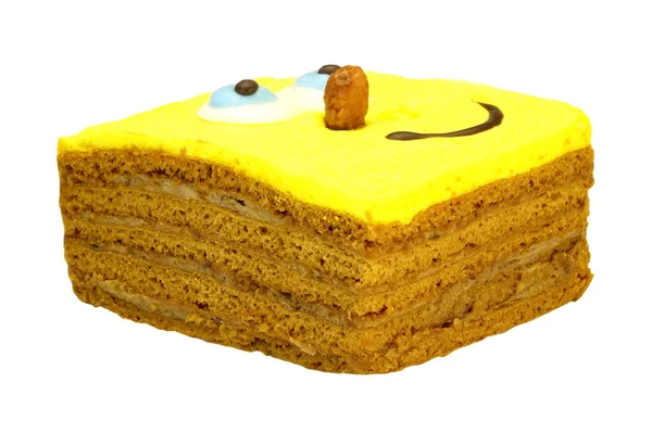 Bolo Brownie com rosto amarelo sorridente humano isolado em branco — Fotografia de Stock