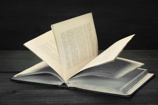 Megnyitott régi kopott könyv homályos szöveg fa háttér — Stock Fotó