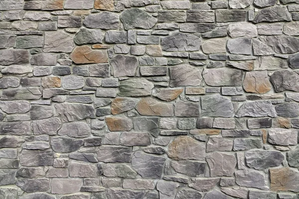 Moderne strukturierte Steinmauer aus Steinplatten und Sandsteinplatten — Stockfoto